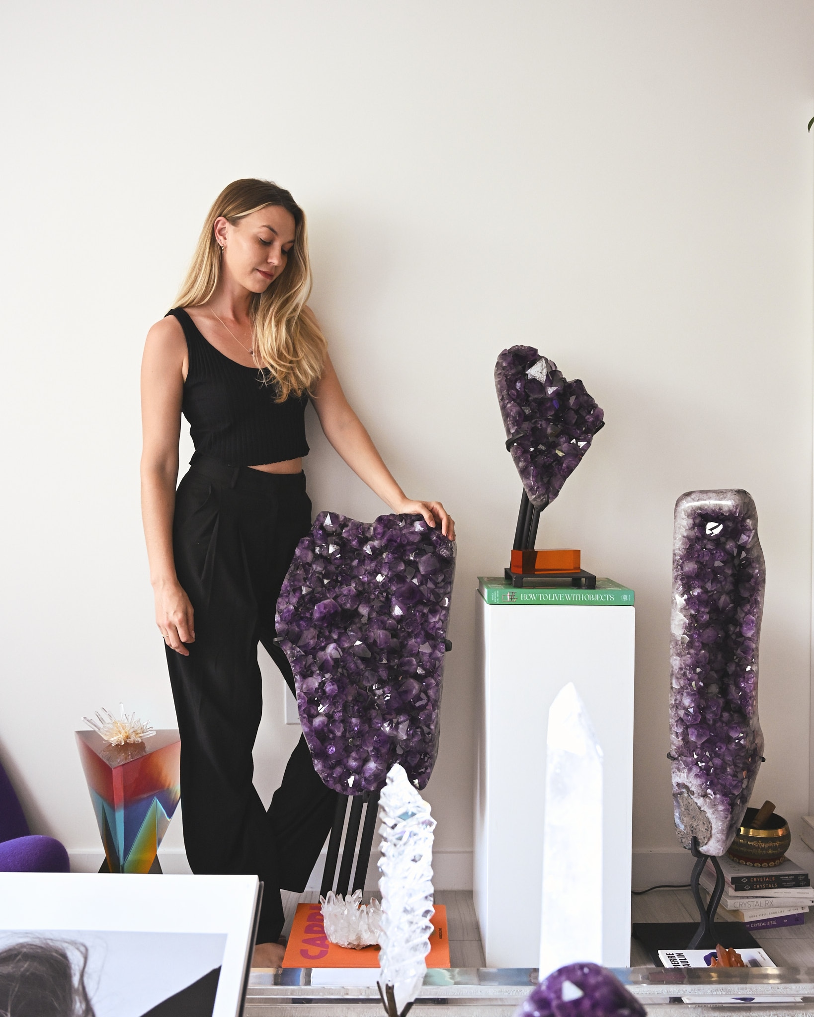 Brittany Roughton in studio with museum-quality mineral specimens, founder of Crystals.com