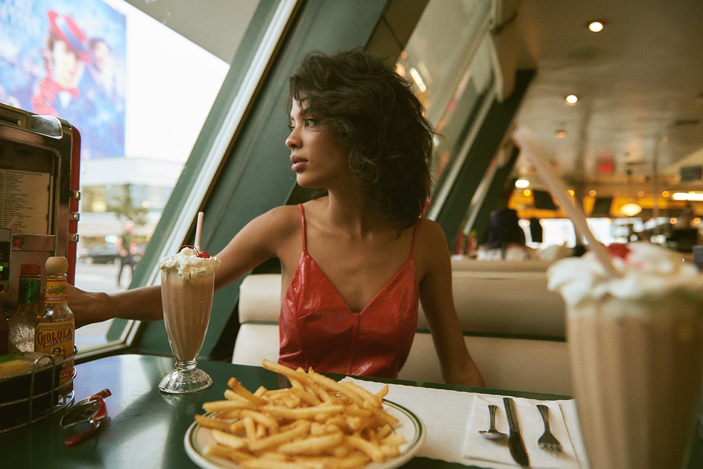 Diner editorial, red leather booth, milkshakes, cinematic light